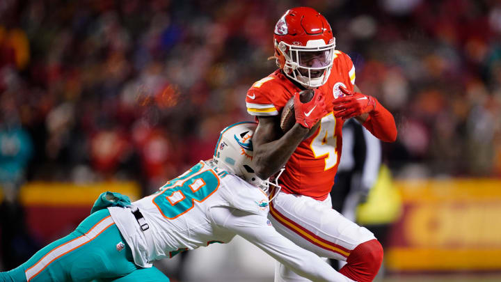 Jan 13, 2024; Kansas City, Missouri, USA; Kansas City Chiefs wide receiver Rashee Rice (4) moves the ball ahead of Miami Dolphins cornerback Ethan Bonner (38) during the first half of the 2024 AFC wild card game at GEHA Field at Arrowhead Stadium. Mandatory Credit: Jay Biggerstaff-USA TODAY Sports