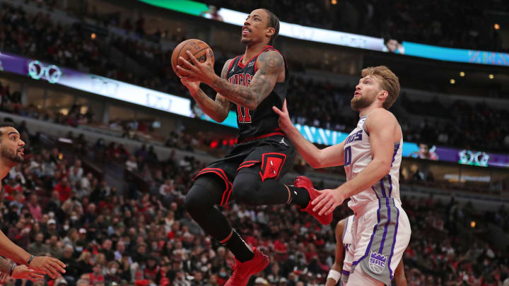 Feb 16, 2022; Chicago, Illinois, USA; Chicago Bulls forward DeMar DeRozan (11) shoots past Sacramento Kings forward Domantas Sabonis (10) during the second quarter at the United Center. Mandatory Credit: Dennis Wierzbicki-USA TODAY Sports