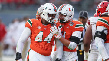 Dec 28, 2023; Bronx, NY, USA; Miami Hurricanes defensive lineman Rueben Bain Jr. (44) and linebacker Francisco Mauigoa (51) celebrates after a defensive stop during the first half of the 2023 Pinstripe Bowl against the Rutgers Scarlet Knights at Yankee Stadium. Mandatory Credit: Vincent Carchietta-USA TODAY Sports