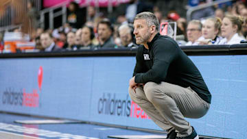 Mar 12, 2024; Kansas City, MO, USA; West Virginia Mountaineers coach Josh Eilert watches game play during the first half against the Cincinnati Bearcats at T-Mobile Center. Mandatory Credit: William Purnell-Imagn Images