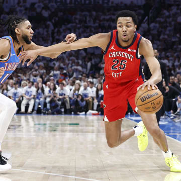 Apr 24, 2024; Oklahoma City, Oklahoma, USA; New Orleans Pelicans guard Trey Murphy III (25) drives around Oklahoma City Thunder guard Isaiah Joe (11) during the second quarter of game two of the first round for the 2024 NBA playoffs at Paycom Center.