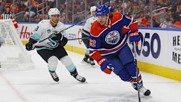 Oct 6, 2023; Edmonton, Alberta, CAN; Edmonton Oilers forward Raphael Lavoie (62) protects the puck from Seattle Kraken defensemen Brian Dumoulin (8) during the first period at Rogers Place. Mandatory Credit: Perry Nelson-Imagn Images