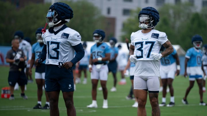 The Tennessee Titans' Chidobe Awuzie (13) and Amani Hooker (37) run through warmups on the first day of training camp at Ascension Saint Thomas Sports Park Wednesday, July 24, 2024.