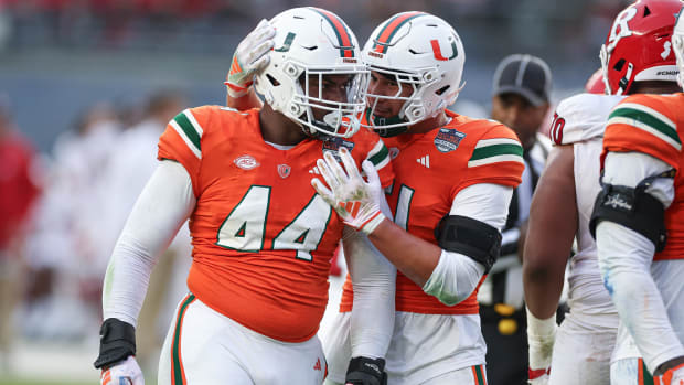 Miami Hurricanes defensive lineman Rueben Bain Jr. (44) and linebacker Francisco Mauigoa (51) celebrates after a defensive st