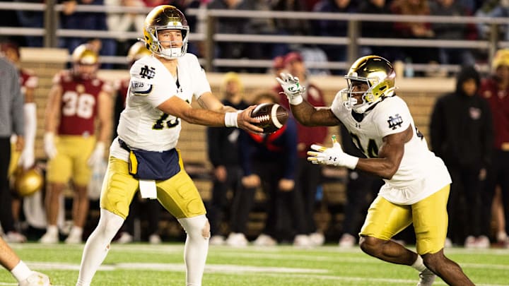 Nov 1, 2025; Chestnut Hill, Massachusetts, USA; Notre Dame Fighting Irish quarterback CJ Carr (13) gives the ball to running back Jadarian Price (24) during the fourth quarter against the Boston College Eagles at Alumni Stadium. Mandatory Credit: Edward Finan-Imagn Images
