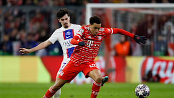 Bayern Munich attacking midfielder Jamal Musiala dribbling past PSG midfielder Vitinha in the 22/23 UCL RO16 clash. 