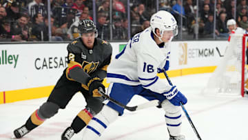 Oct 24, 2022; Las Vegas, Nevada, USA; Toronto Maple Leafs right wing Mitchell Marner (16) takes a slash from Vegas Golden Knights defenseman Zach Whitecloud (2) during the first period at T-Mobile Arena. Mandatory Credit: Stephen R. Sylvanie-Imagn Images