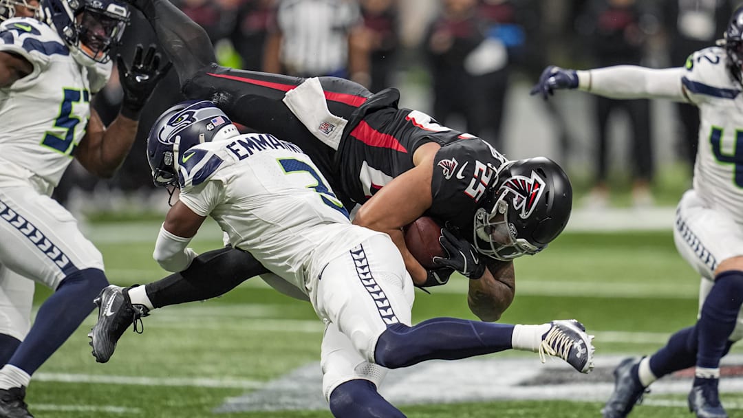 Dec 7, 2025; Atlanta, Georgia, USA; Seattle Seahawks safety Nick Emmanwori (3) upends Atlanta Falcons running back Tyler Allgeier (25) during the first half at Mercedes-Benz Stadium. Mandatory Credit: Dale Zanine-Imagn Images