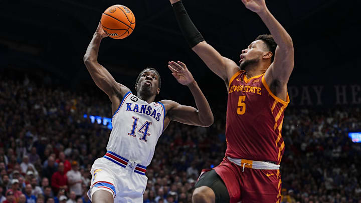Jan 13, 2026; Lawrence, Kansas, USA; Kansas Jayhawks guard Melvin Council Jr. (14) goes up for a dunk against Iowa State Cyclones forward Joshua Jefferson (5) during the second half at Allen Fieldhouse. Mandatory Credit: Jay Biggerstaff-Imagn Images