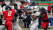 Mandarin quarterback Tramell Jones (1) throws downfield as Miami Columbus edge rushers Dylan Stephenson (2) and Willis McGahee IV (17) close in during the FHSAA Class 4M high school football championship game on December 8, 2023. [Clayton Freeman/Florida Times-Union]