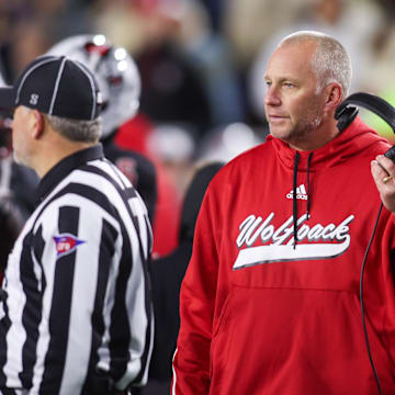 Nov 21, 2024; Atlanta, Georgia, USA; North Carolina State Wolfpack head coach Dave Doeren talks to a referee against the Georgia Tech Yellow Jackets in the fourth quarter at Bobby Dodd Stadium at Hyundai Field. 
