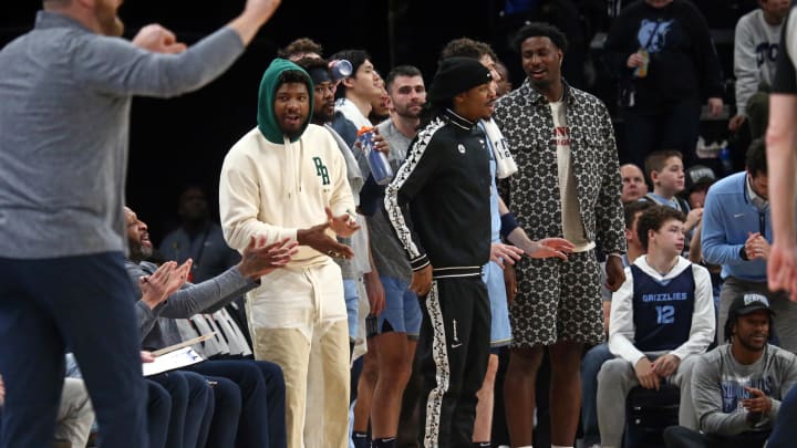 Mar 2, 2024; Memphis, Tennessee, USA; Memphis Grizzlies guard Marcus Smart (left), guard Ja Morant (middle) and forward-center Jaren Jackson Jr. (right) react from the bench during the first half against the Portland Trail Blazers at FedExForum. Mandatory Credit: Petre Thomas-USA TODAY Sports