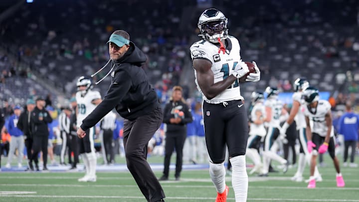 Oct 9, 2025; East Rutherford, New Jersey, USA; Philadelphia Eagles wide receiver A.J. Brown (11) warms up with wide recivers coach Aaron Moorehead prior to the game against the New York Giants at MetLife Stadium. Mandatory Credit: Brad Penner-Imagn Images