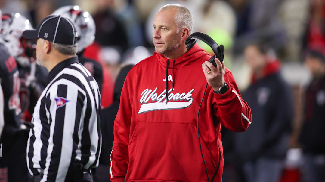 Nov 21, 2024; Atlanta, Georgia, USA; North Carolina State Wolfpack head coach Dave Doeren talks to a referee against the Georgia Tech Yellow Jackets in the fourth quarter at Bobby Dodd Stadium at Hyundai Field. Mandatory Credit: Brett Davis-Imagn Images