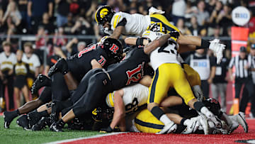 Sep 19, 2025; Piscataway, New Jersey, USA; Rutgers Scarlet Knights quarterback Athan Kaliakmanis (16) scores a rushing touchdown against the Iowa Hawkeyes during the first half at SHI Stadium. Mandatory Credit: Vincent Carchietta-Imagn Images