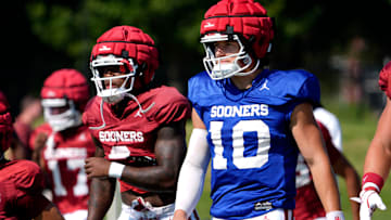Oklahoma's John Mateer warms up before a fall camp practice.