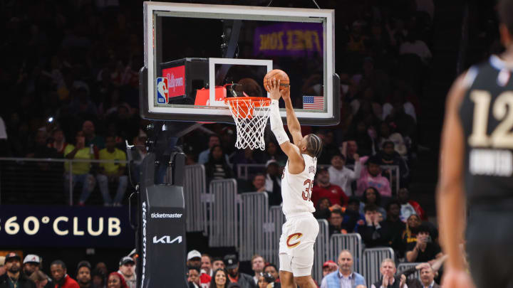 Mar 6, 2024; Atlanta, Georgia, USA; Cleveland Cavaliers forward Isaac Okoro (35) dunks after stealing the ball from Atlanta Hawks forward De'Andre Hunter (12) in the second half at State Farm Arena. Mandatory Credit: Brett Davis-USA TODAY Sports
