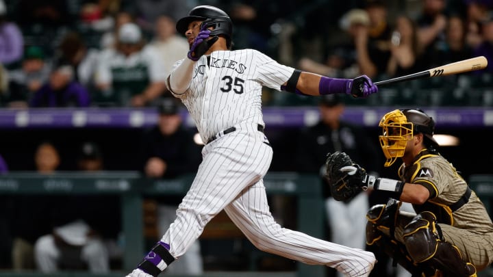 Apr 24, 2024; Denver, Colorado, USA; Colorado Rockies catcher Elias Diaz (35) hits a solo home run in the eighth inning against the San Diego Padres at Coors Field. 