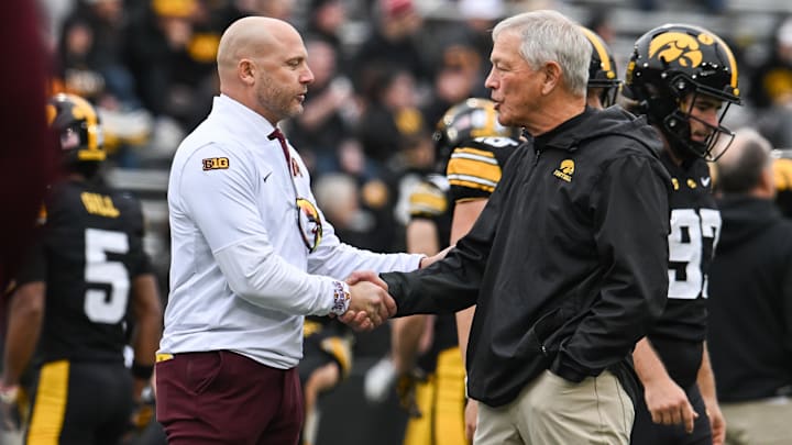 Oct 25, 2025; Iowa City, Iowa, USA; Minnesota Golden Gophers head coach P.J. Fleck (left) shakes hands with Iowa Hawkeyes head coach Kirk Ferentz before the game at Kinnick Stadium. Mandatory Credit: Jeffrey Becker-Imagn Images