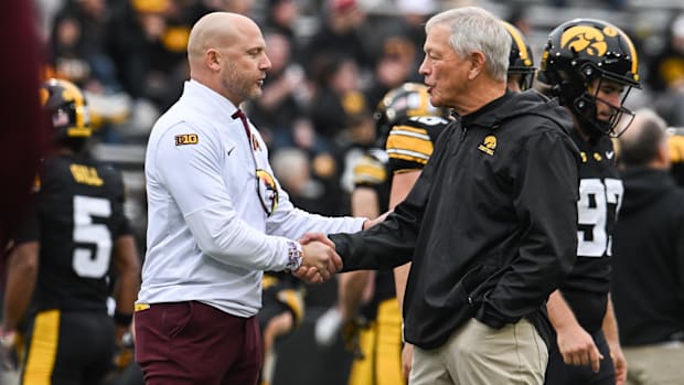 Gophers head coach P.J. Fleck (left) shakes hands with Iowa Hawkeyes head coach Kirk Ferentz 