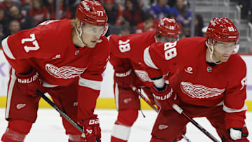 Nov 9, 2024; Detroit, Michigan, USA;  Detroit Red Wings defenseman Simon Edvinsson (77) and right wing Patrick Kane (88) get set during a face off against the New York Rangers at Little Caesars Arena. Mandatory Credit: Rick Osentoski-Imagn Images