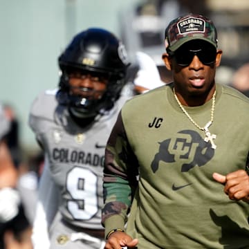 Nov 11, 2023; Boulder, Colorado, USA; Colorado Buffaloes head coach Deion Sanders runs on to the field before the first half against the Arizona Wildcats at Folsom Field. Mandatory Credit: Ron Chenoy-Imagn Images