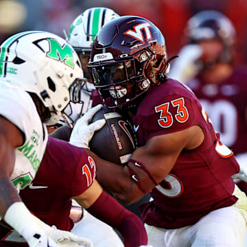 Sep 7, 2024; Blacksburg, Virginia, USA; Virginia Tech Hokies running back Bhayshul Tuten (33) runs the ball during the second quarter against the Marshall Thundering Herd at Lane Stadium. Mandatory Credit: Peter Casey-Imagn Images