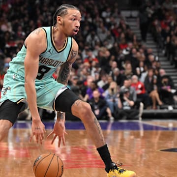 Mar 28, 2025; Toronto, Ontario, CAN;  Charlotte Hornets guard Nick Smith Jr. (8) controls the ball against the Toronto Raptors in the second half at Scotiabank Arena. Mandatory Credit: Dan Hamilton-Imagn Images