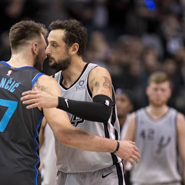 Jan 16, 2019; Dallas, TX, USA; Dallas Mavericks forward Luka Doncic (77) shakes hands with San Antonio Spurs guard Marco Belinelli (18) after their game at the American Airlines Center. Mandatory Credit: Jerome Miron-Imagn Images
