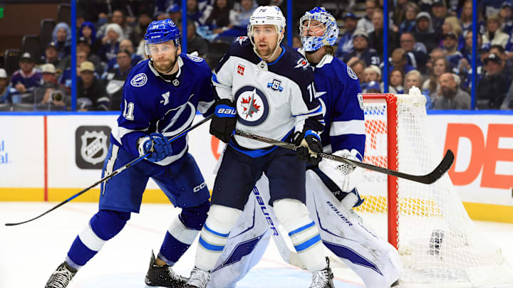 Winnipeg Jets forward Tanner Pearson (70) looks for room in front of Tampa Bay Lightning goaltender Andrei Vasilevskiy (88) 