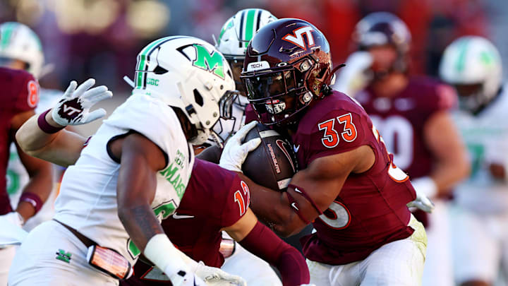 Sep 7, 2024; Blacksburg, Virginia, USA; Virginia Tech Hokies running back Bhayshul Tuten (33) runs the ball during the second quarter against the Marshall Thundering Herd at Lane Stadium. Mandatory Credit: Peter Casey-Imagn Images