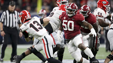 Alabama Crimson Tide defensive lineman Tim Smith (50) pressures Georgia Bulldogs quarterback Stetson Bennett (13) during the SEC championship game at Mercedes-Benz Stadium.