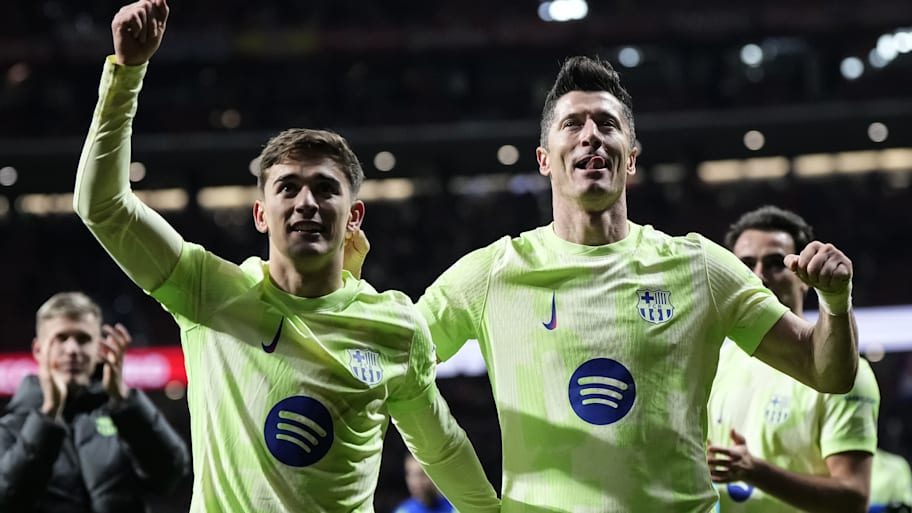 Gavi (left) and Robert Lewandowski celebrating.
