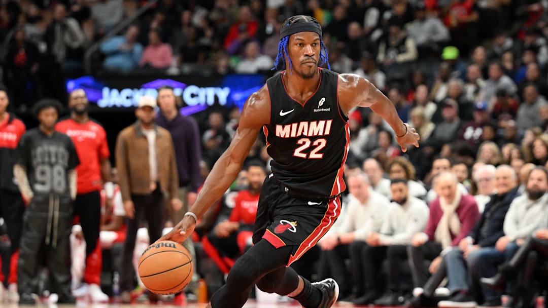 Dec 1, 2024; Toronto, Ontario, CAN;  Miami Heat forward Jimmy Butler (22) dribbles the ball against the Toronto Raptors in the first half at Scotiabank Arena. Mandatory Credit: Dan Hamilton-Imagn Images