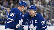 Sep 22, 2024; Toronto, Ontario, CAN;  Toronto Maple Leafs forwards Auston Matthews (34) and John Tavares (91) talk before taking a faceoff against the Ottawa Senators in the third period at Scotiabank Arena. Mandatory Credit: Dan Hamilton-Imagn Images
