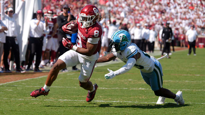 Oklahoma Sooners running back Taylor Tatum (8) runs past Tulane Green Wave safety Kevin Adams III (23) fro a touchdown during a college football game between the University of Oklahoma Sooners (OU) and the Tulane Green Wave at Gaylord Family - Oklahoma Memorial Stadium in Norman, Okla., Saturday, Sept. 14, 2024.