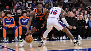 Apr 1, 2025; New York, New York, USA; New York Knicks forward OG Anunoby (8) drives to the basket while being defended by Philadelphia 76ers guard Lonnie Walker IV (16) during the first half at Madison Square Garden. Mandatory Credit: John Jones-Imagn Images