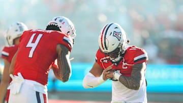 Oct 26, 2024; Tucson, Arizona, USA; Arizona Wildcats quarterback Noah Fifita (11) does handshake with Arizona Wildcats wide receiver Tetairoa McMillan (4) before the game against West Virginia Mountaineers at Arizona Stadium. Mandatory Credit: Aryanna Frank-Imagn Images