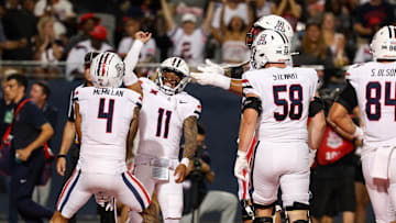 Aug 31, 2024; Tucson, Arizona, USA; Arizona Wildcats wide receiver Tetairoa McMillan (4) celebrates touchdown with Arizona Wildcats quarterback Noah Fifita (11) during first quarter at Arizona Stadium. Mandatory Credit: Aryanna Frank-Imagn Images