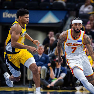 Oct 31, 2025; Indianapolis, Indiana, USA; Atlanta Hawks guard Nickeil Alexander-Walker (7) dribbles the ball while Indiana Pacers guard RayJ Dennis (10) defends in the second half at Gainbridge Fieldhouse. Mandatory Credit: Trevor Ruszkowski-Imagn Images