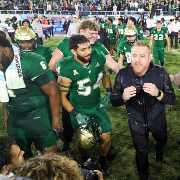 Dec 21, 2023; Boca Raton, FL, USA;  South Florida Bulls head coach Alex Golesh is congratulated after beating the Syracuse Orange in the RoofClaim.com Boca Raton Bowl at FAU Stadium. Mandatory Credit: Nathan Ray Seebeck-USA TODAY Sports