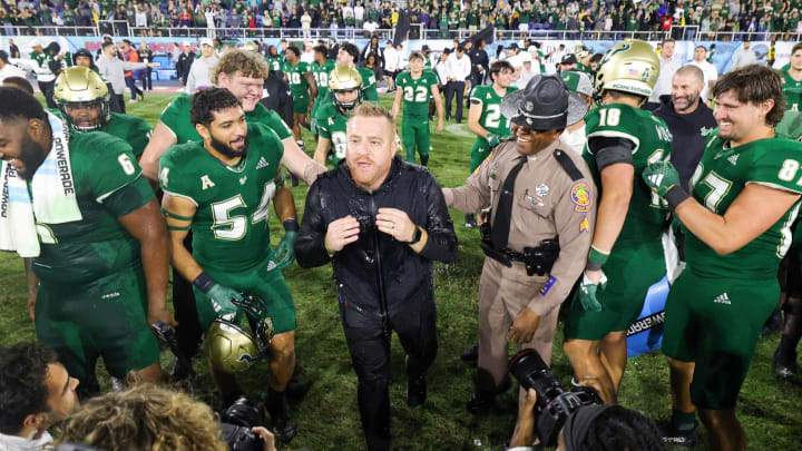 Dec 21, 2023; Boca Raton, FL, USA;  South Florida Bulls head coach Alex Golesh is congratulated after beating the Syracuse Orange in the RoofClaim.com Boca Raton Bowl at FAU Stadium. Mandatory Credit: Nathan Ray Seebeck-USA TODAY Sports