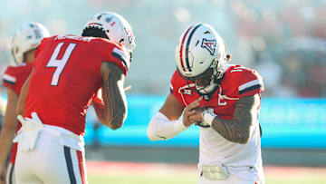Oct 26, 2024; Tucson, Arizona, USA; Arizona Wildcats quarterback Noah Fifita (11) does handshake with Arizona Wildcats wide receiver Tetairoa McMillan (4) before the game against West Virginia Mountaineers at Arizona Stadium.