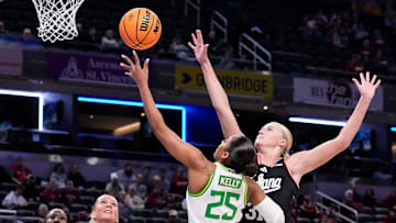 Oregon Ducks guard Deja Kelly (25) goes in for a lay-up against Indiana Hoosiers forward Faith Wiseman (31) during the Big Ten women's tournament at Gainbridge Fieldhouse in Indianapolis.