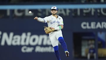Nov 1, 2025; Toronto, Ontario, CAN; Toronto Blue Jays designated hitter Bo Bichette (11) throws to first for an out against Los Angeles Dodgers right fielder Teoscar Hernandez (37) in the eighth inning during game seven of the 2025 MLB World Series at Rogers Centre. Mandatory Credit: John E. Sokolowski-Imagn Images
