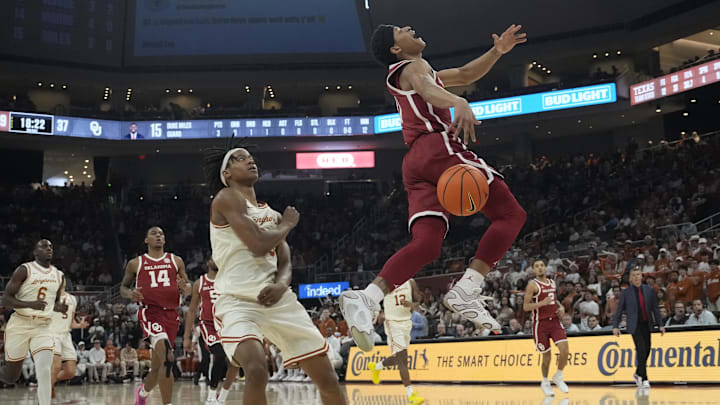 Mar 8, 2025; Austin, Texas, USA; Oklahoma Sooners guard Jeremiah Fears (0) gets fouled by Texas Longhorns guard Tre Johnson (20) while driving to the basket during the second half at Moody Center. Mandatory Credit: Scott Wachter-Imagn Images