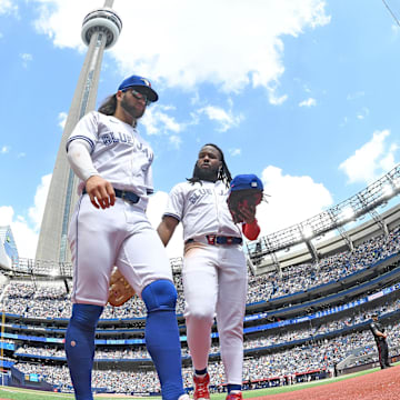 Toronto Blue Jays shortstop Bo Bichette (11, left) and first baseman Vladimir Guerrero Jr. (27) return to the dugout in the sixth inning against the Baltimore Orioles at Rogers Centre on June 6.