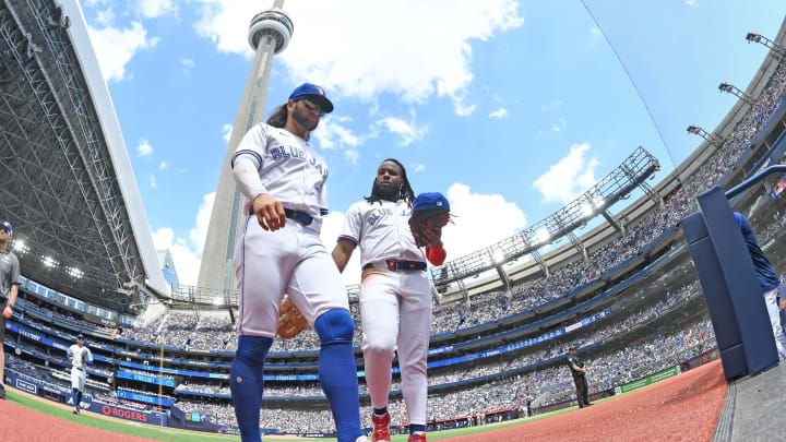 Toronto Blue Jays shortstop Bo Bichette (11, left) and first baseman Vladimir Guerrero Jr. (27) return to the dugout in the sixth inning against the Baltimore Orioles at Rogers Centre on June 6.