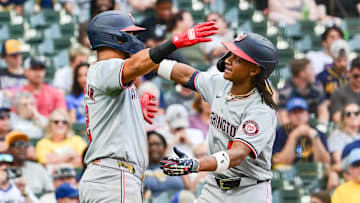 Jul 13, 2024; Milwaukee, Wisconsin, USA; Washington Nationals shortstop C.J. Abrams (5) hugs second baseman Luis Garcia (2) after hitting a 2-run home run against the Milwaukee Brewers in the ninth inning at American Family Field. 