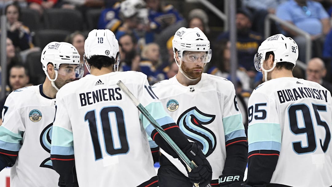 Apr 14, 2024; St. Louis, Missouri, USA; Seattle Kraken defenseman Adam Larsson (6) looks on with center Matty Beniers (10) and left wing Andre Burakovsky (95) during the thrid period of a hockey game against the St. Louis Blues at Enterprise Center. Mandatory Credit: Jeff Le-Imagn Images